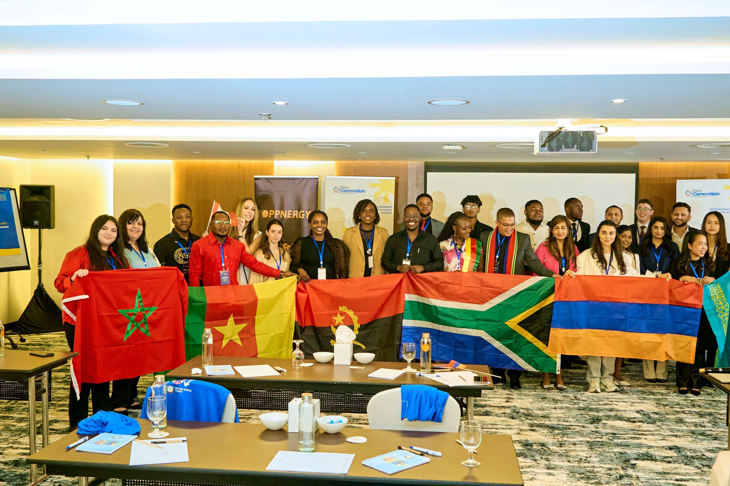 Delegates standing in a line holding the national flags of their countries